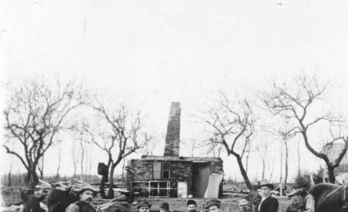 Beskrivelse. 
Grunden udgraves til det nye stuehus på gården Grønvang 1894.
Bemærkning. Tilhører bibliotekar Hans Drewsens samling.
,,,,,,,,,,,,,,,,,
Starten på Grønvang går helt tilbage til  Anders Hansen 1738-1800. I følge Vragwiki.
I nyere tid købte   Peder Lauridsen  1807-1880 Gården i 1835.
Det er et utroligt billede.
Det må have været et hårdt arbejde at bygge et hus i 18. hundrede  tallet. Her med skovl og tunge træ trillebøre.
Det må havde været Grønvangs stuehus som der blev bygget dengang.
Det hvide hus må havde været det første af Grønvang.
Johannes Lauridsen blev født på gården Grønvang i 1847 og døde i 1920.
og Olav Vang Lauridsen døde i 1956.